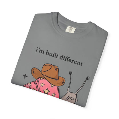 Snail Graphic T-Shirt — "i'm built different like incorrectly i think" Cute Cowpoke Shell Tee
