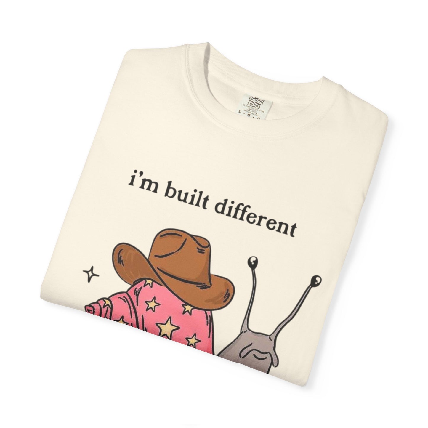Snail Graphic T-Shirt — "i'm built different like incorrectly i think" Cute Cowpoke Shell Tee