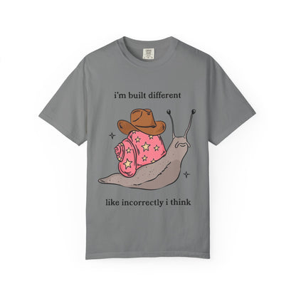 Snail Graphic T-Shirt — "i'm built different like incorrectly i think" Cute Cowpoke Shell Tee